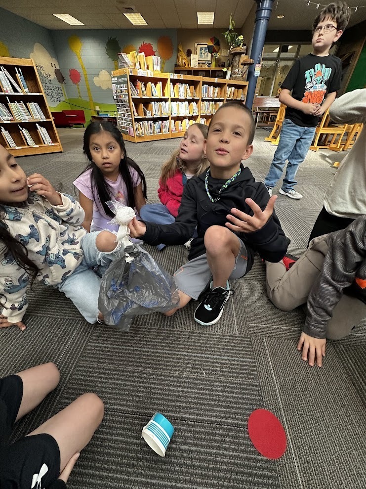 Students around a dropped egg.