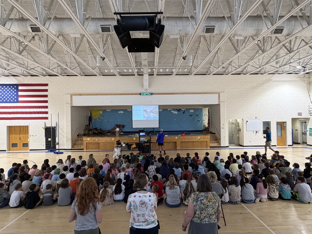 Image of 3rd and 4th grade students watching presentation.
