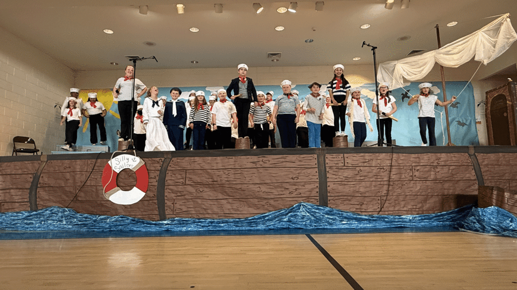 Cast and 4th graders signing.