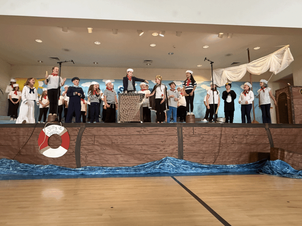 Students on stage for 4th grade musical.