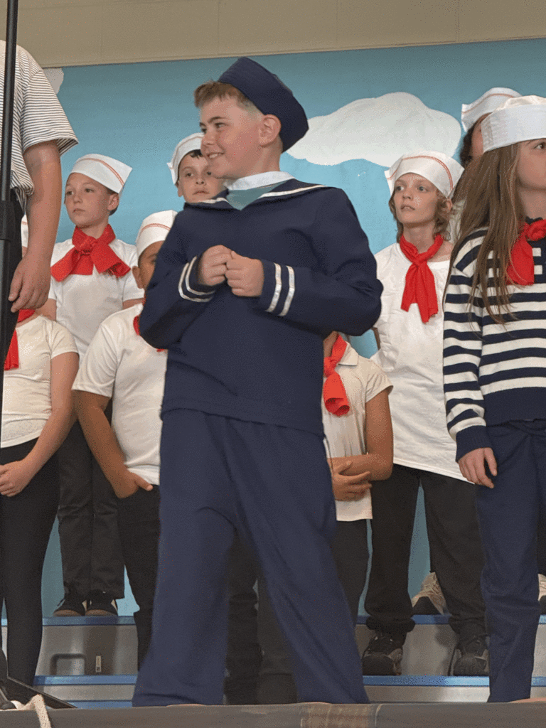 Cast sailor saying lines during musical.
