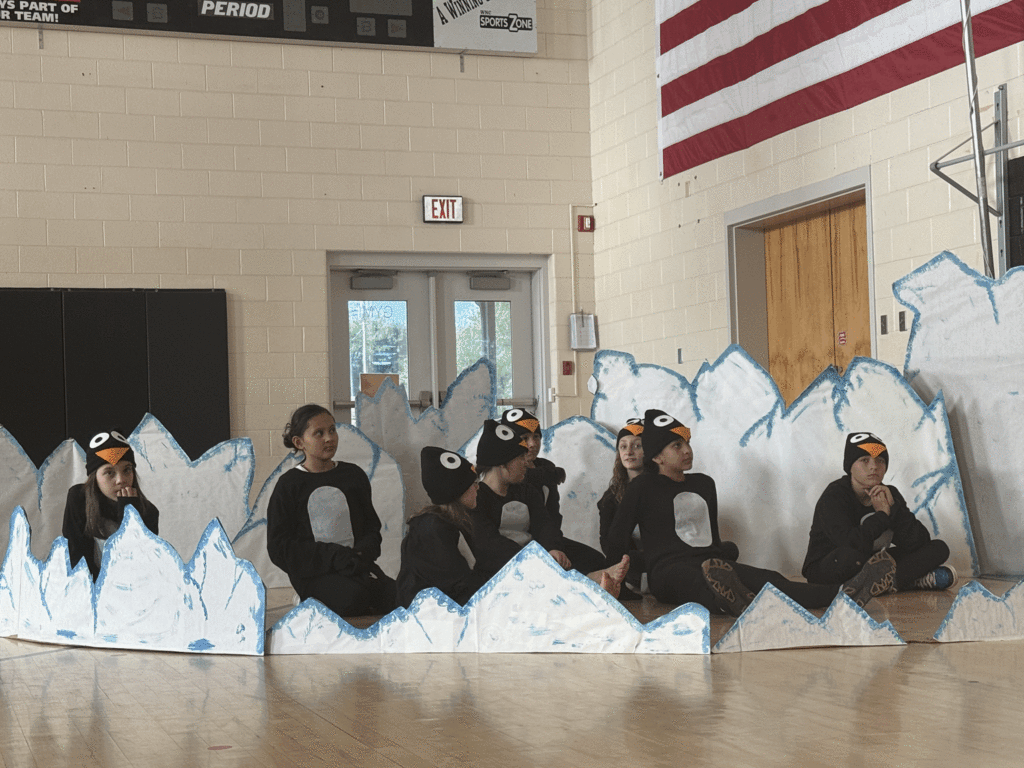 Dancing penguins off stage during musical.