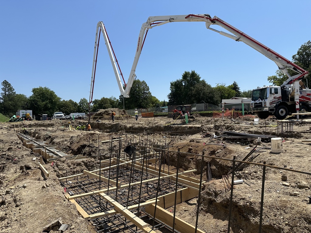 Concrete footings being poured.