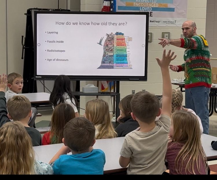 kindergartners learn about dinosaurs from Dr. Deccechi, DSU