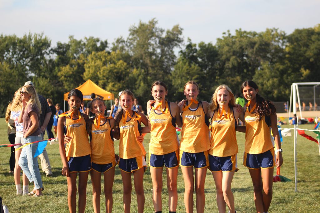 Girls cross country team with medals