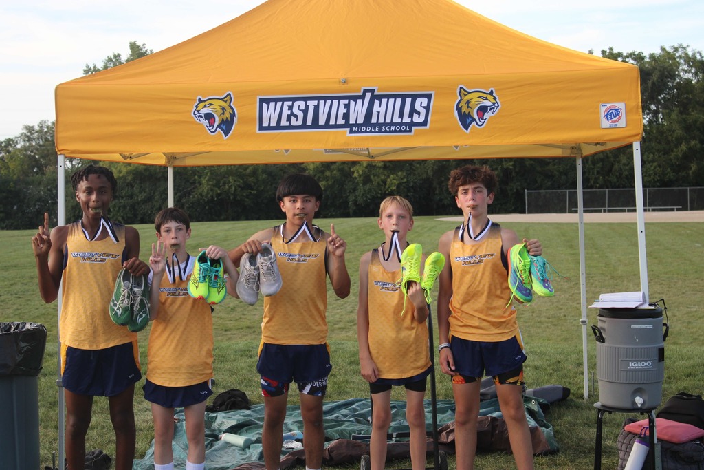 Cross country runners with medals and shoes