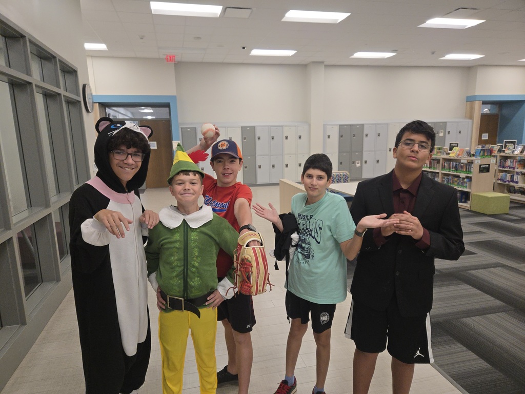 Five students dressed in various quirky outfits pose for the camera