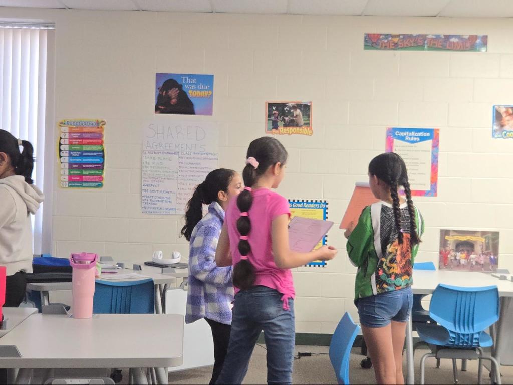 A group of girls work together in the classroom