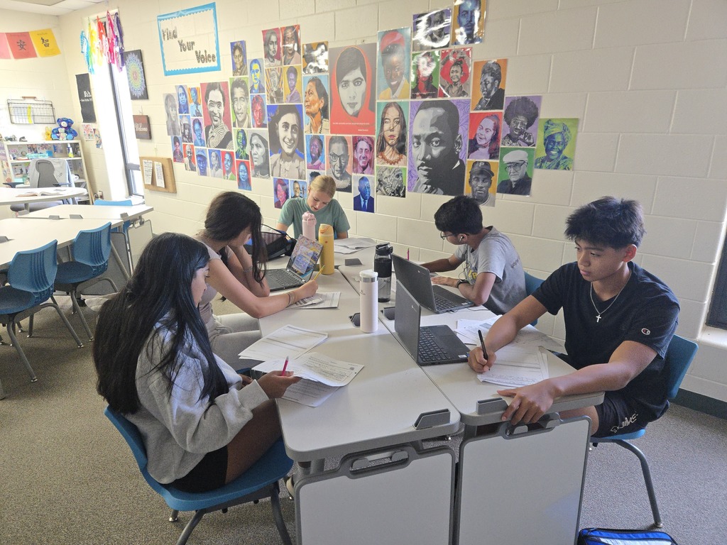 Students work at a table together
