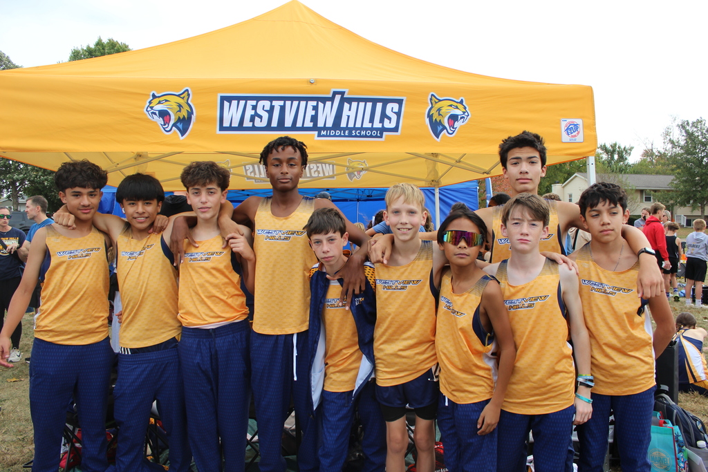 The boys cross country team smiles at the camera