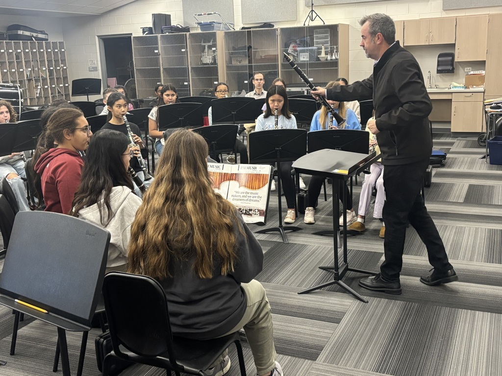 Students sit with their instruments as they learn from Shawn Maxwell