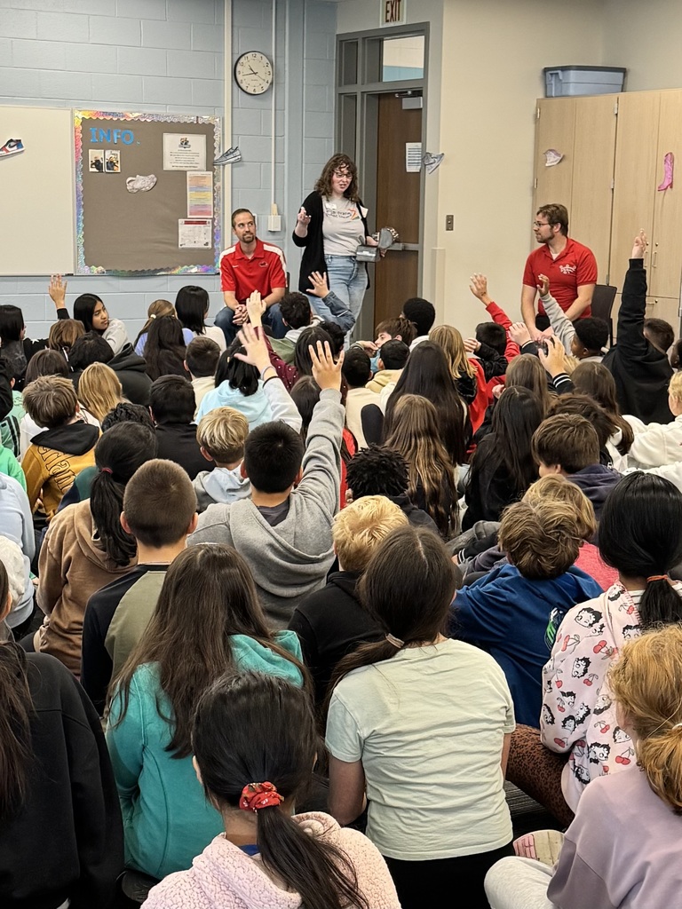 Laura speaks to a crowd of students in a classroom