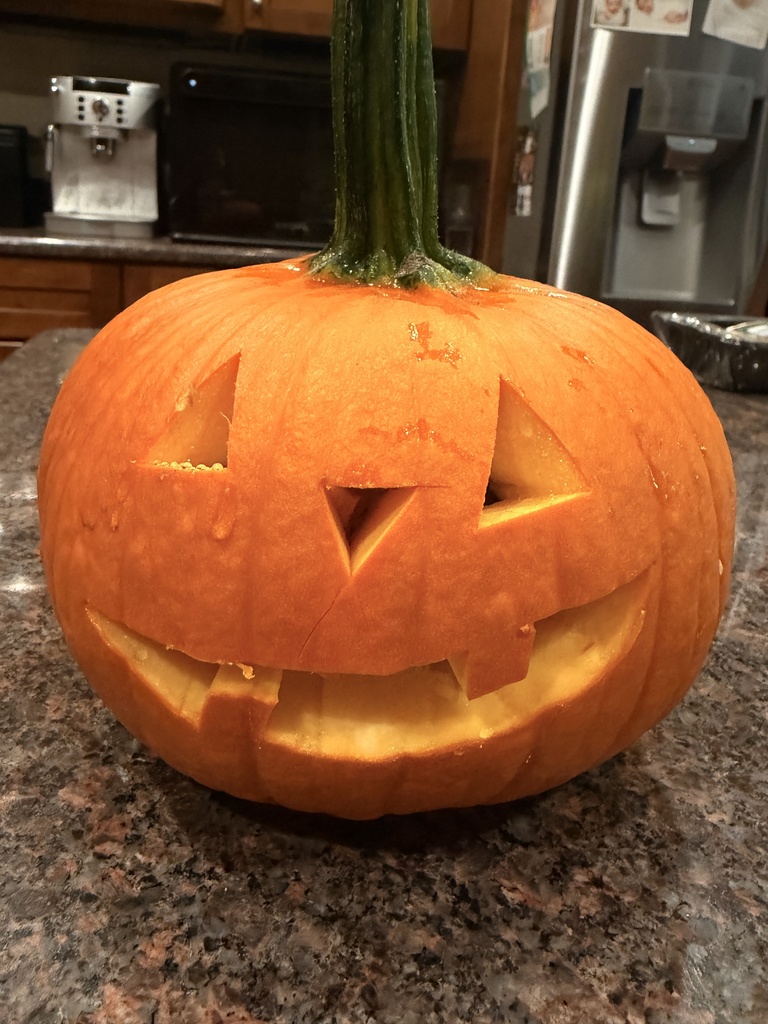 The pumpkin is carved like a jack o'lantern and is in perfect condition after being carved