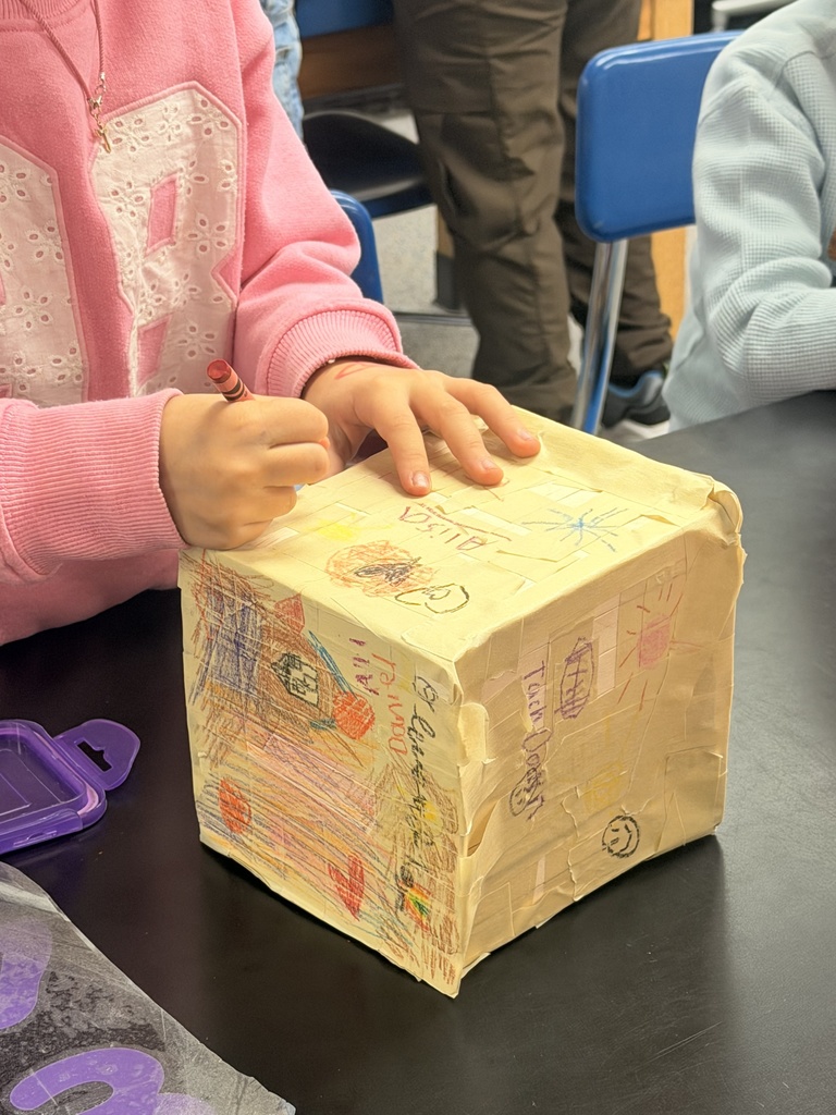 Students decorate their box with crayon drawings