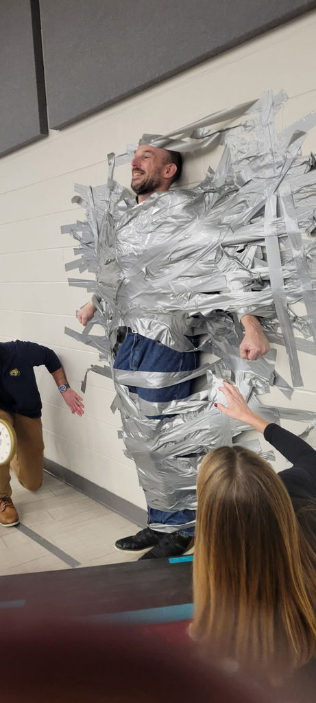 Principal duct taped to the wall