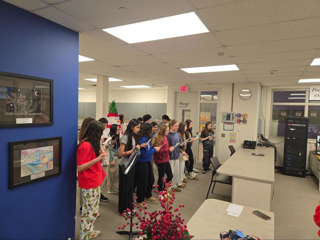 Students carol and play instruments