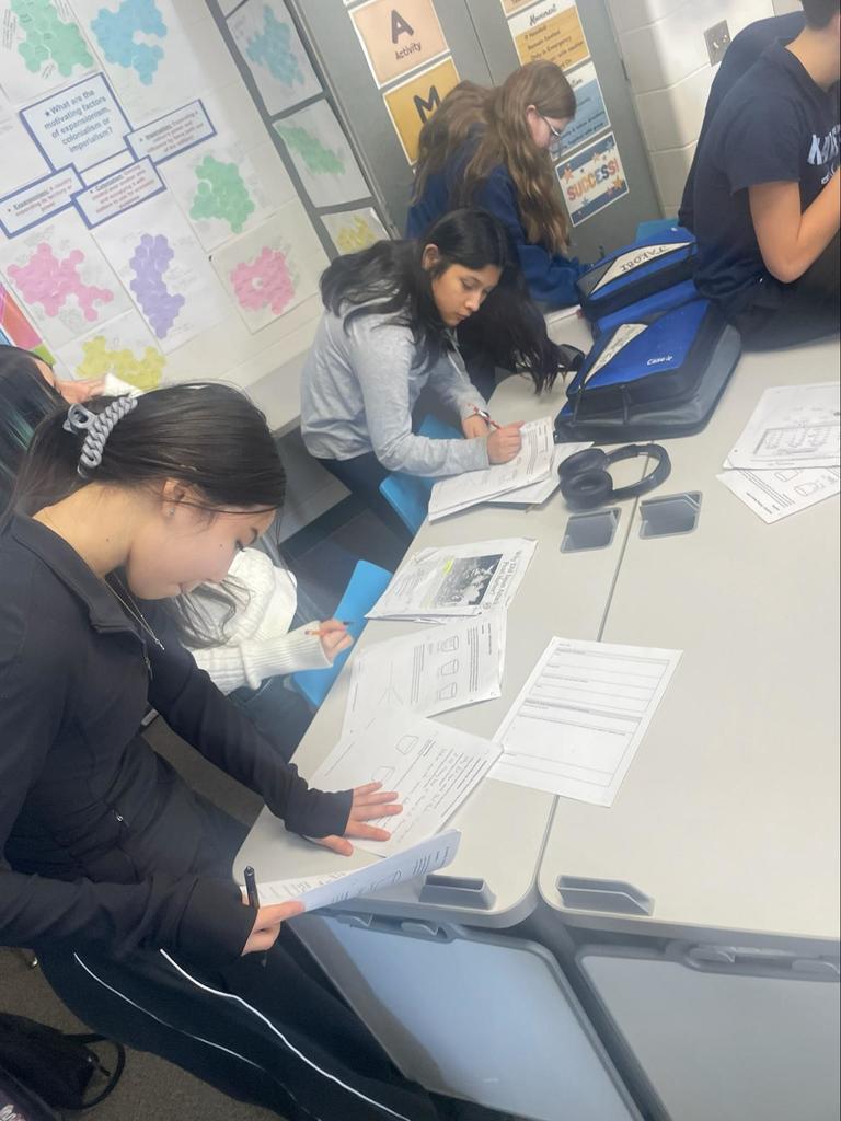 Kids conduct research and discuss with each other in class