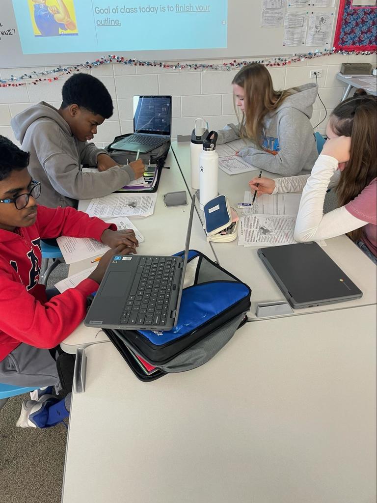 Kids conduct research and discuss with each other in class