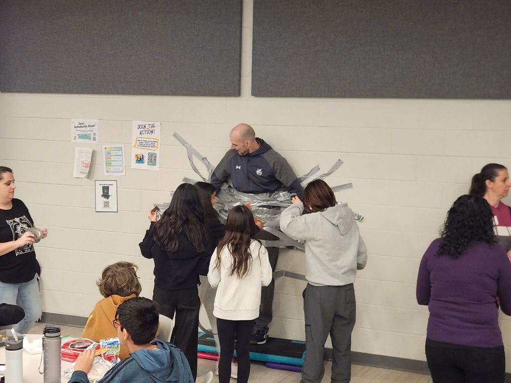 Principal duct taped to the wall