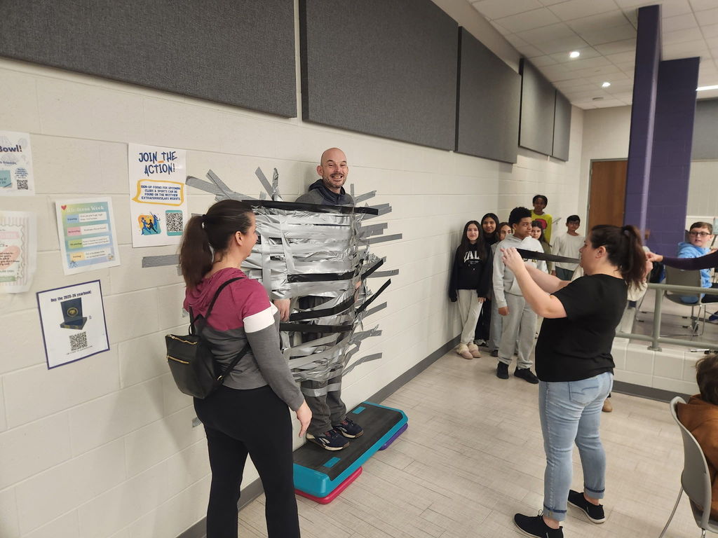 Principal duct taped to the wall