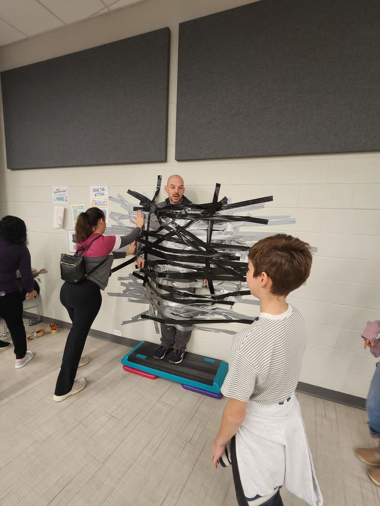 Principal duct taped to the wall