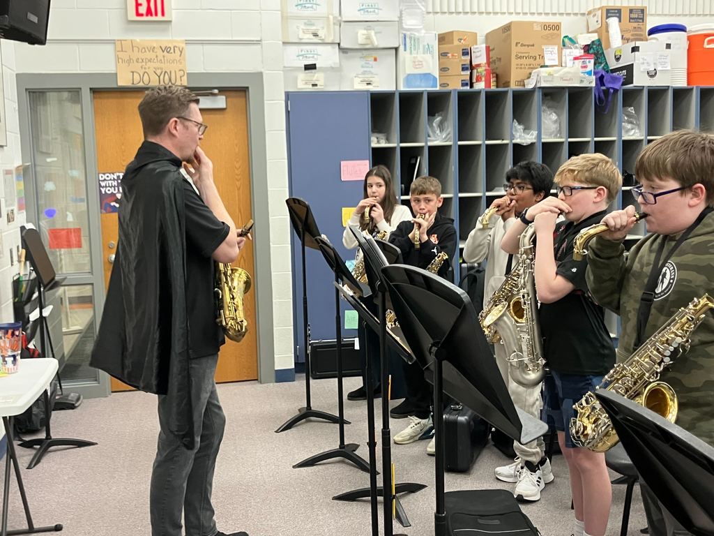 Ted Holtz works with students playing saxophones