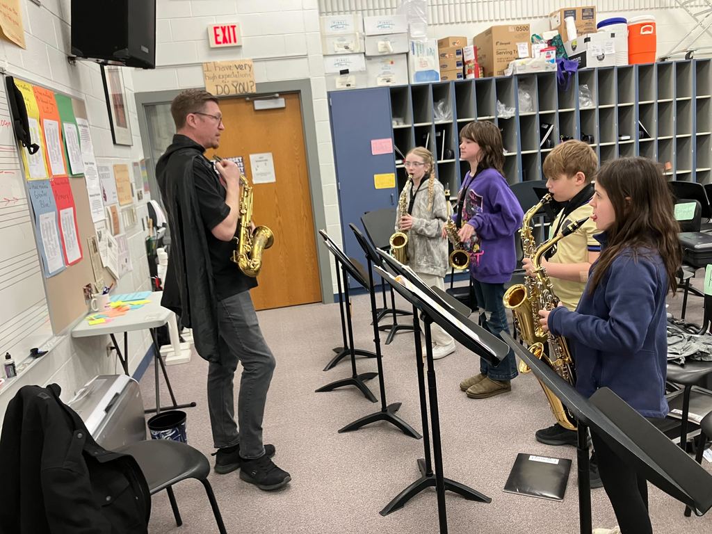 Ted Holtz works with students playing saxophones