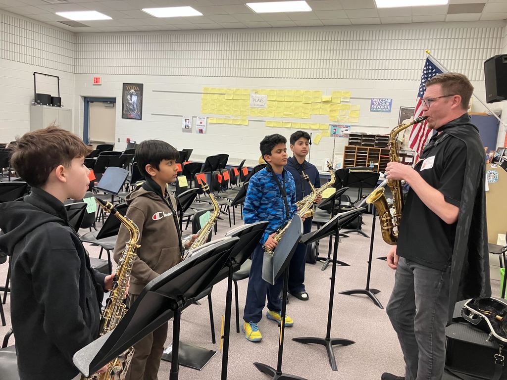 Ted Holtz works with students playing saxophones