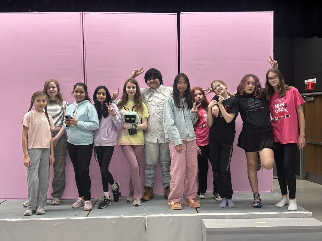 The Westview Drama Club poses in front of the pink set
