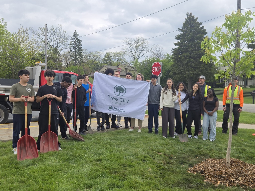 Students pose with a banner saying Tree City USA - Arbor Foundation