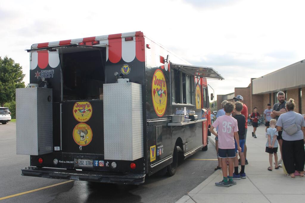 A food truck serves food to families at the event