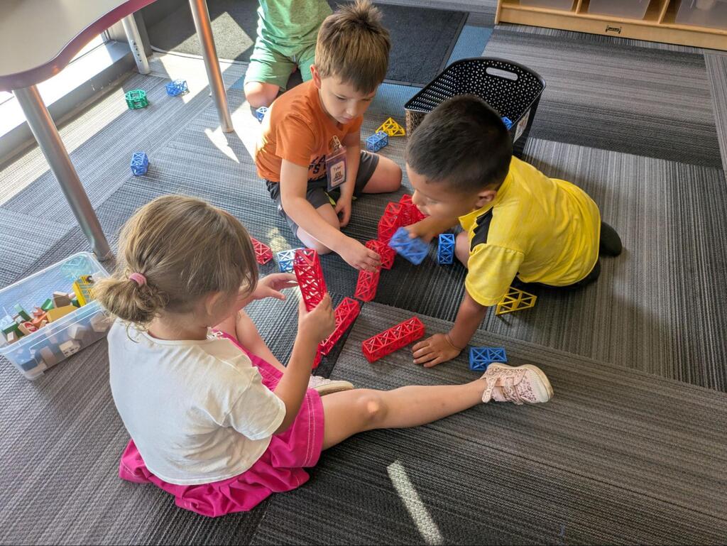 young students playing together on the floor