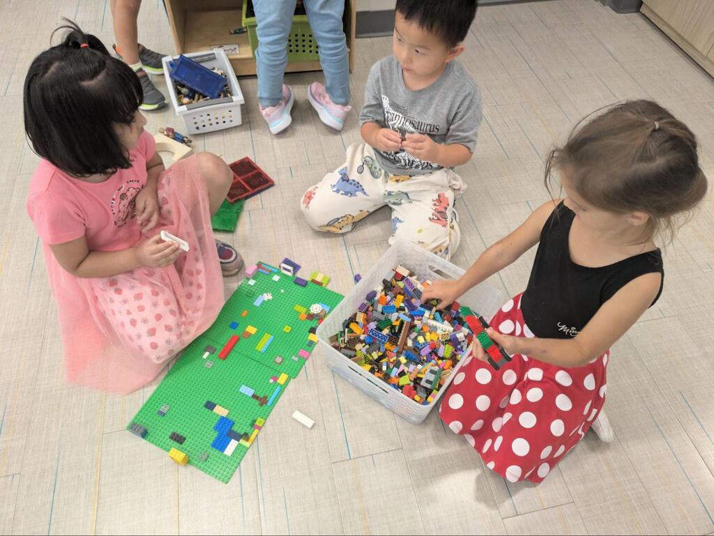 young students playing together on the floor