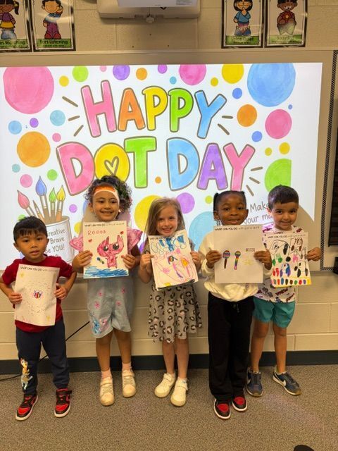 students standing in front of sign that reads happy dot day