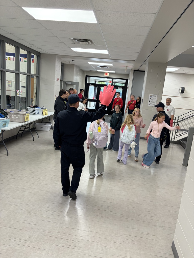 firefighters high fiving students
