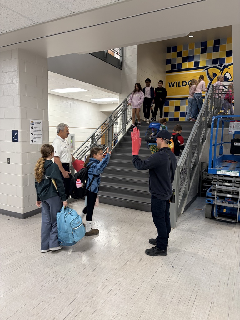 firefighters high fiving students