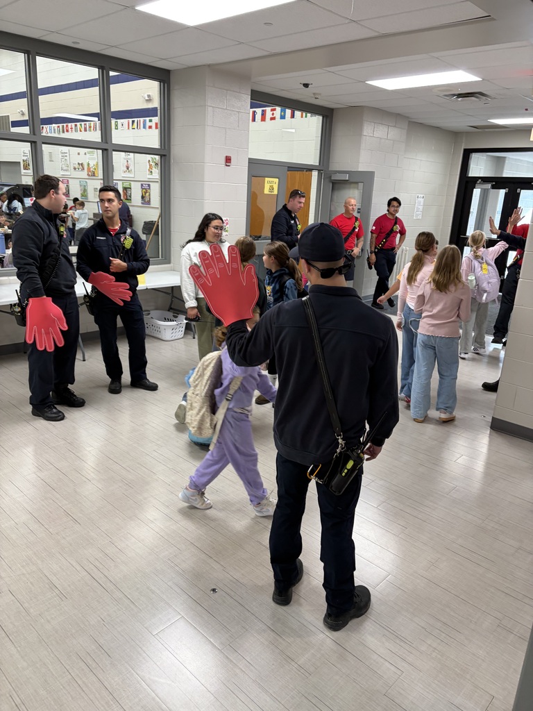 firefighters high fiving students