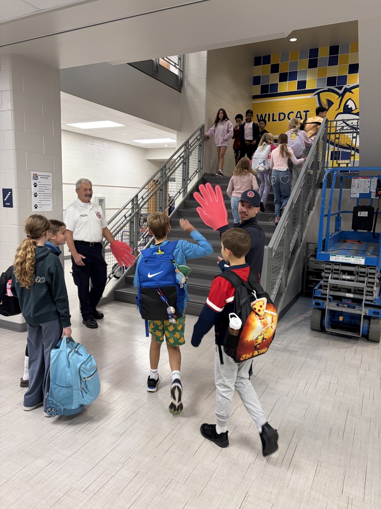 firefighters high fiving students