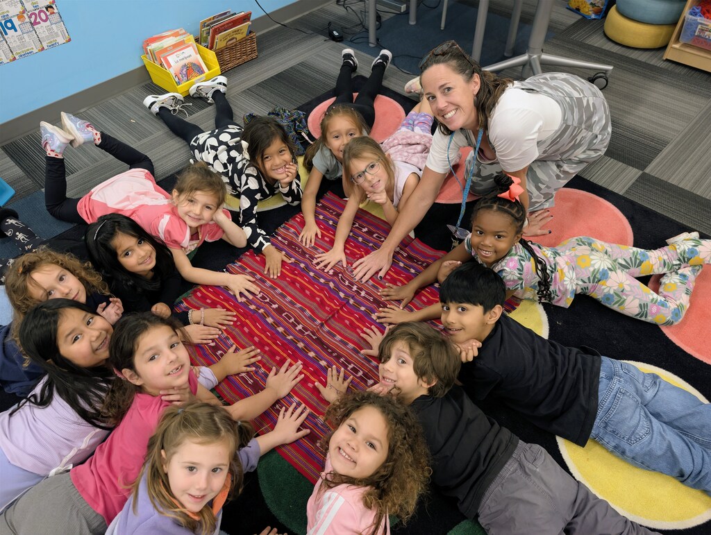students touching fabric on ground