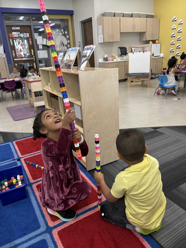 Kids playing with tall towers of blocks