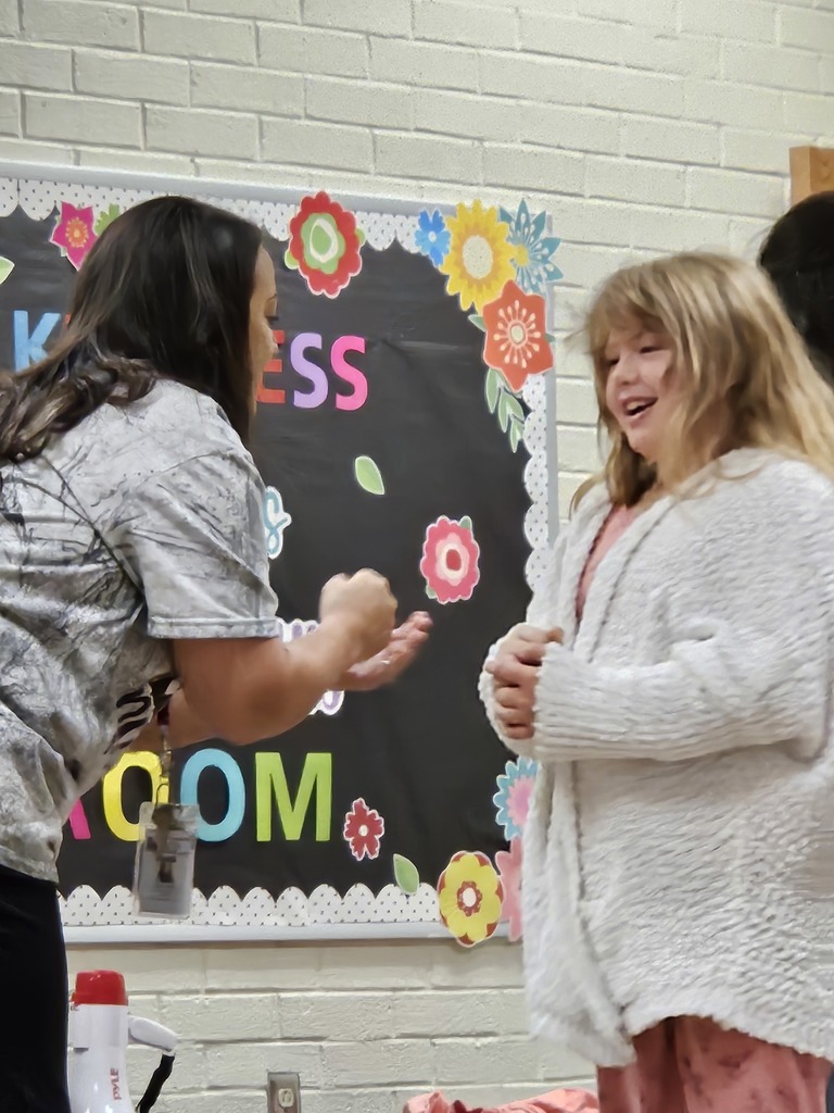 Mrs. Hughes playing Rock Paper Scissors with Dixie