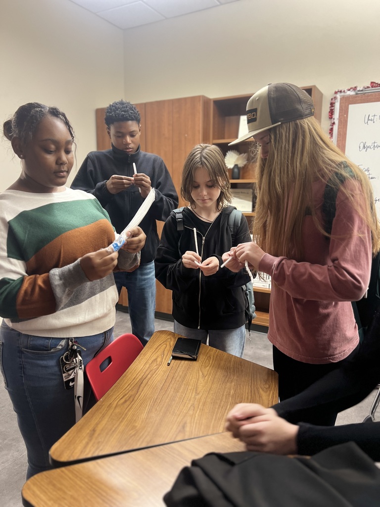 Seventh period students Kayci, Jayden, Kendall, Addy, and Ally crafting holiday class decorations
