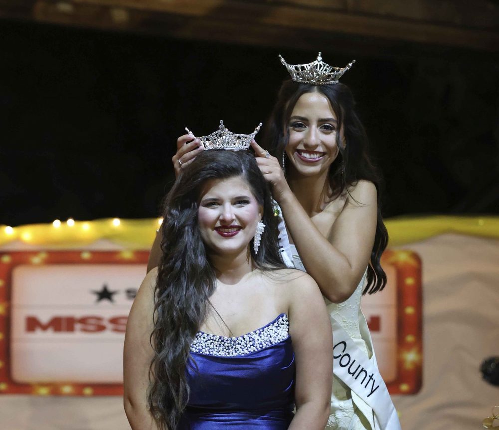 Photo by JIM ARNETT Reigning Miss Magoffin County Kennedy Conley crowned the newest to the title, Miss Magoffin County Erin Grace Rudd, Friday night during Founder's Day events. Rudd also won the Sunshine Award.