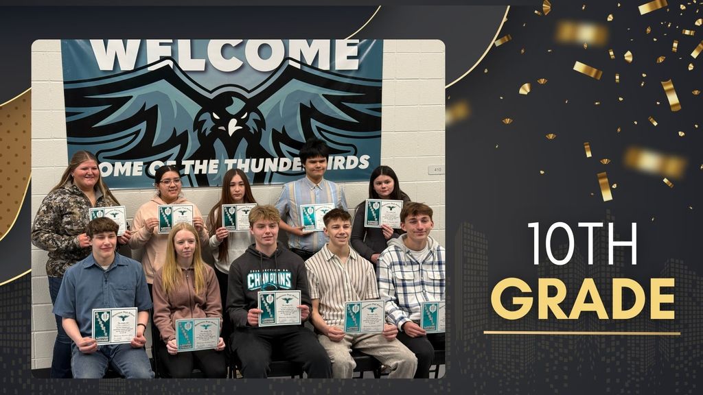 Group of 10th grade students holding academic award certificates, posed in rows in front of a school banner.