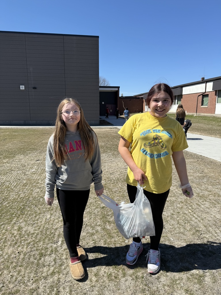 Kids outside cleaning up the school yard