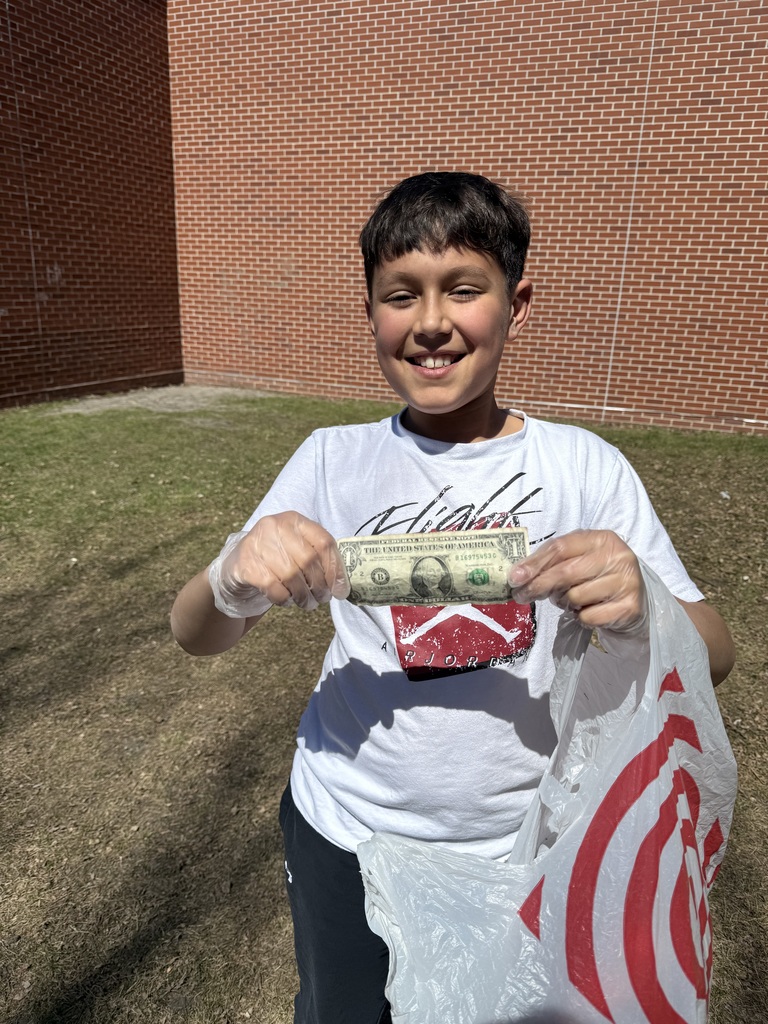 Kids outside cleaning up the school yard
