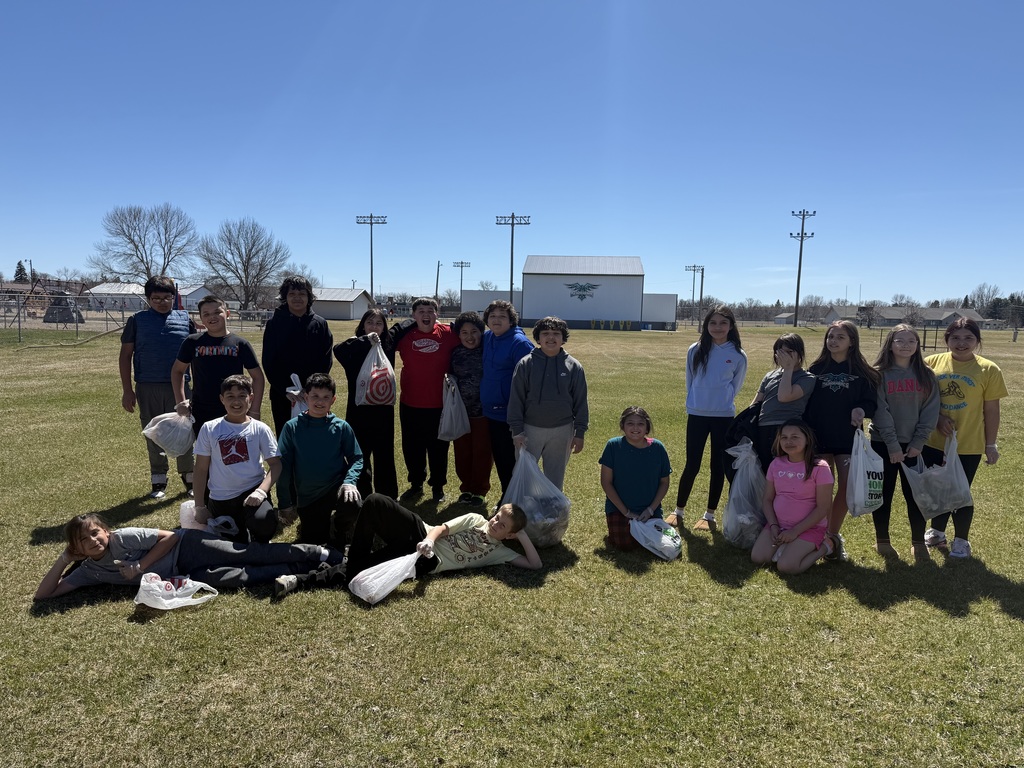 Kids outside cleaning up the school yard