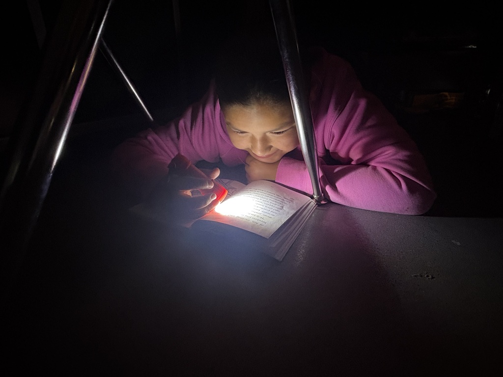 Students reading in the dark
