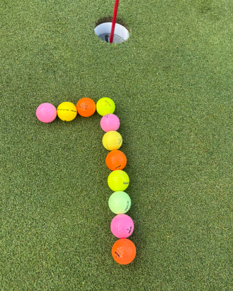 The number seven made out of golf balls