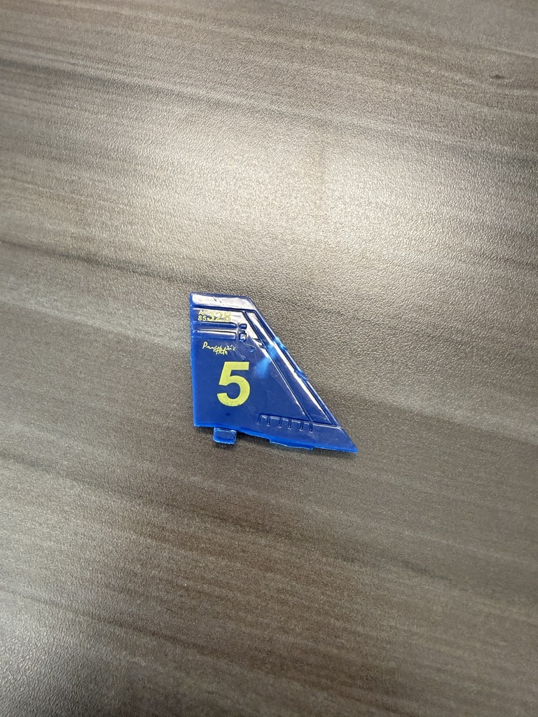 The number five on a blue shape